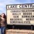 Samantha Kowalski (12) and Mary Beggs (12) stand in front of Lake Central’s sign which recognizes their achievement as National Merit Scholar semi-finalists. The two girls are the only ones at Lake Central to receive this honor this year.