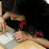 Jovana Dodevska (10) cuts out her rose from the linoleum. This was the most time-consuming part of the project.