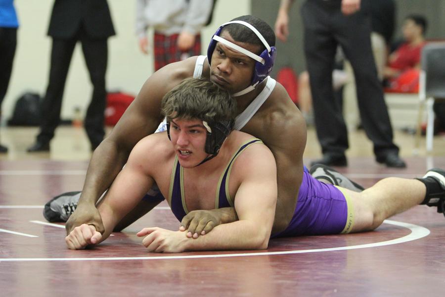 Gelen Robinson (12) holds his opponent to the ground. Robinson was one of the two individual Regional champions for the Indians.