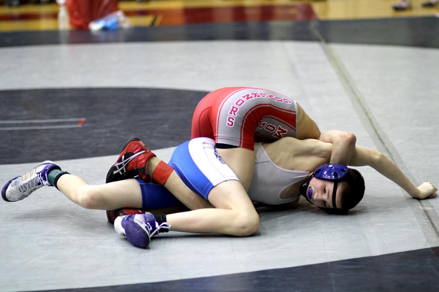 Maxwell King (9) tries to free himself from his competitor. King finished third at the 106 weight class.