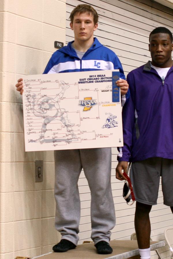 Kodie Christenson (11) stands on the top level of the podium. Christenson was one of the three individual Sectional Champions for the Indians.