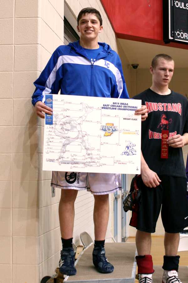 Jacob Kleimola (10) shows off his winning bracket and first place ribbon. Kleimola won his first Sectional Championship at the 160 weight class.