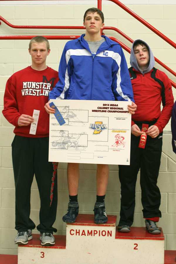 Jacob Kleimola (10) holds up his Regional bracket. He came out on top of the bracket and won a Regional championship in the 160 weight class.