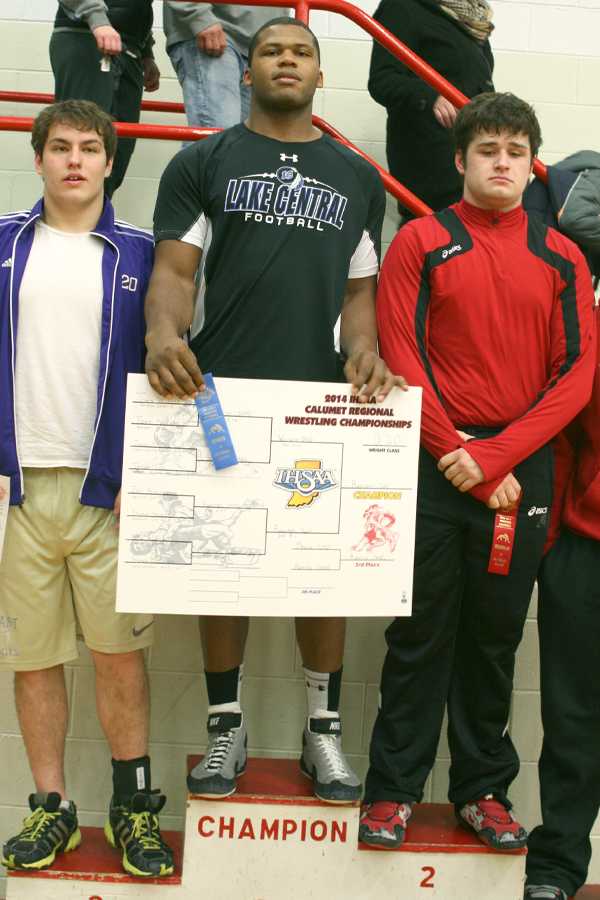 Gelen Robinson (12) towers over his opponents on the podium. This was Robinson’s third Regional title in a row.
