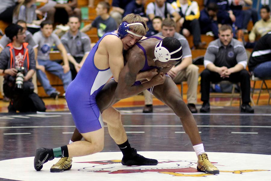Kodie Christenson (11) grabs a hold of his opponent with a strong grip. Christenson helped contribute to the Indians’ total team score of 238 points.