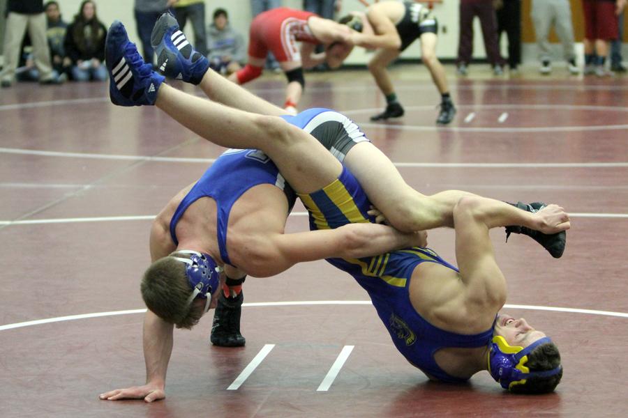 Kodie Christenson (11) tries to turn his competitor to the mat. Christenson advanced to the finals but ended up in second place at his weight class.