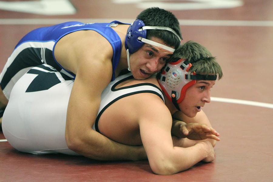 Daniel Vargas (12) holds his opponent to the ground as the clock runs out of time. Vargas ended up qualifying for the Semi-State competition.