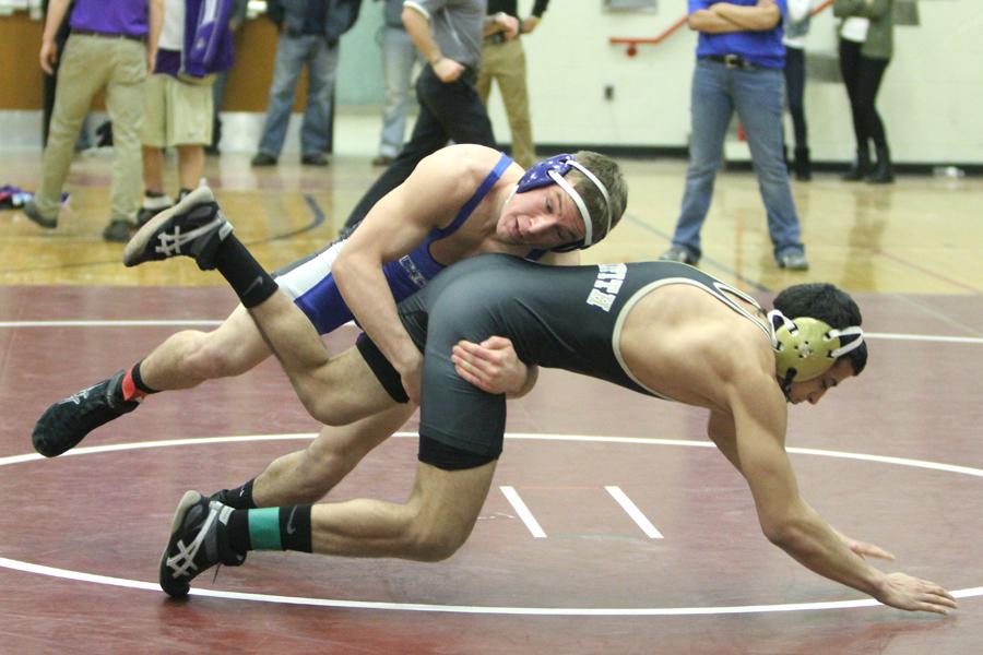 Kodie Christenson (11) forces his opponent to the mat. Winning two of his matches, he contributed to the Indian’s total team score of 107.5 points.