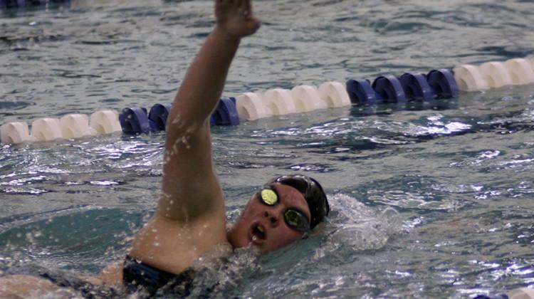 Maura Lake (11) swims the 500 freestyle on Dec. 12. Lake was one of five varsity girls to swim this event.