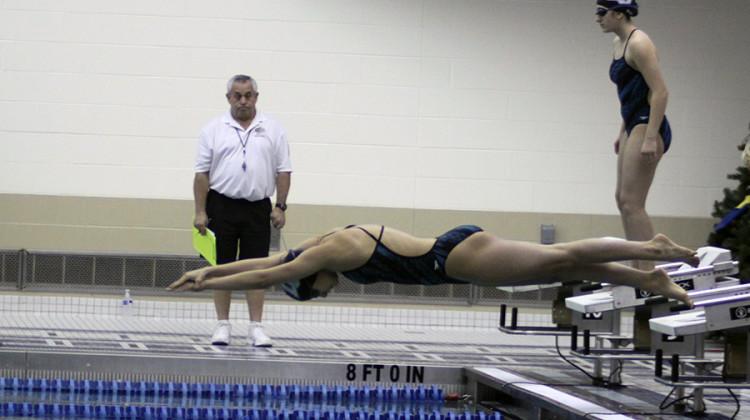 Victoria Springman (12) dives in during the varsity 200 freestyle relay. Springman swam this relay with Marina Vasquez (12), Savanna Spears (10) and Jillian Murray (9).