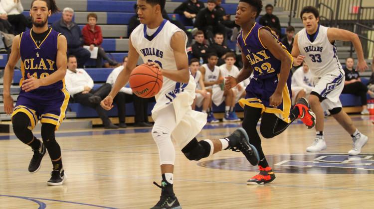 Keon Sellers (10) dribbles the ball down the court. The JV boys played against Clay High School on Saturday, Jan. 30.