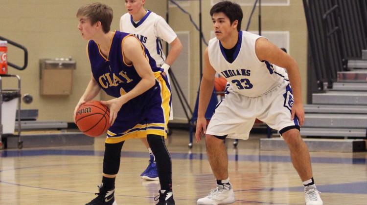 Justin Graciano (10) guards an opponent from Clay High School. The Indians won the game with a final score of 70-19.