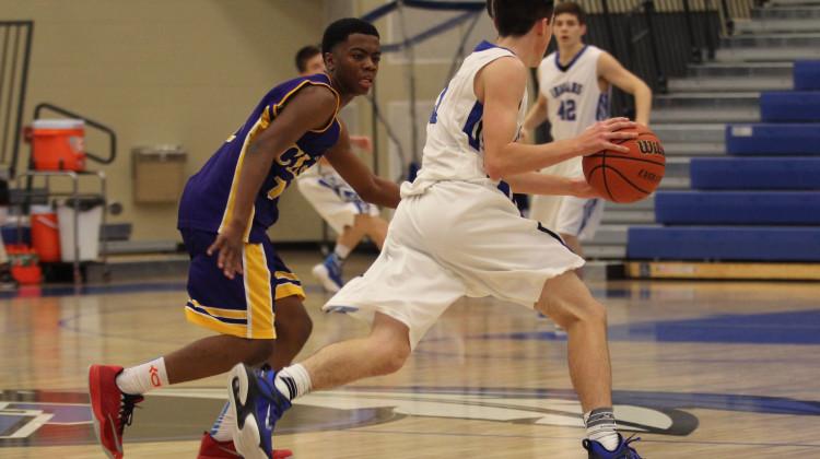 Truman Yahne (10) runs the ball down the court. Yahne played guard throughout the game.