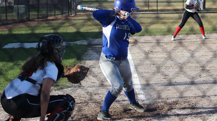 Paige Carter (12) prepares to hit the ball. Carter played second base during the Munster game.