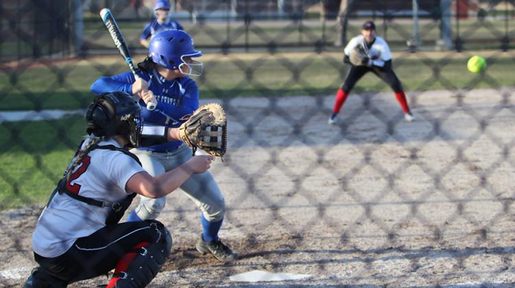 Paige Carter (12) takes a swing against the Munster Mustangs. The Lady Indians beat Munster 9-3.