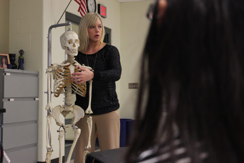 Mrs. Parks demonstrates where the jugular notch is. Students were able to touch and see the skeleton up close after the lesson was over. 