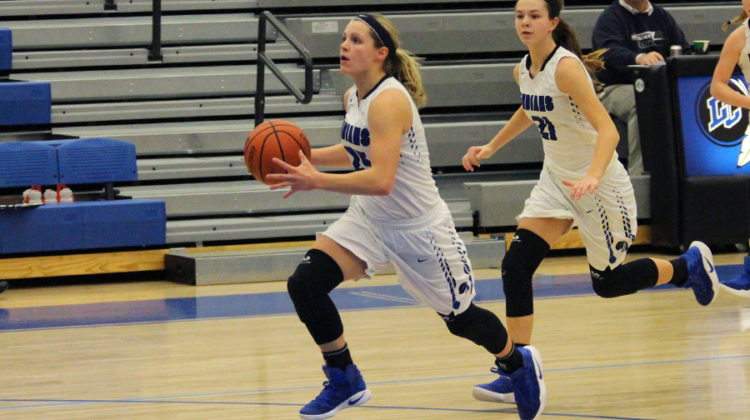 Meghan Long (10) runs down the court with the ball. The girls played Michigan City.