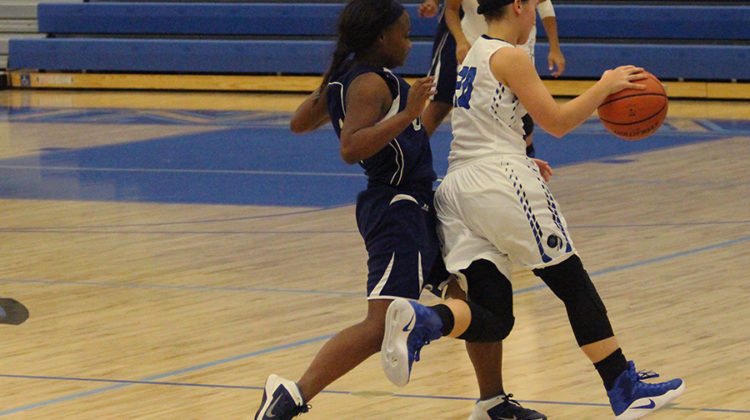 Madison Dulski (9) guards the ball to stop her opponent from her hands on it. The score at half-time was 36-2.