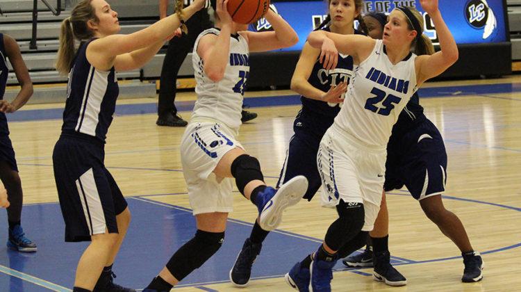 Bailey Fehrman (10) and Meghan Long (10) try to get the ball away from the opposing team. The final score was 57-17.