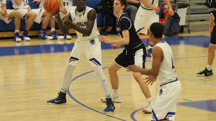 Norell Smith (12) passes the ball to his teammate. The boys tied up the game and eventually got ahead.