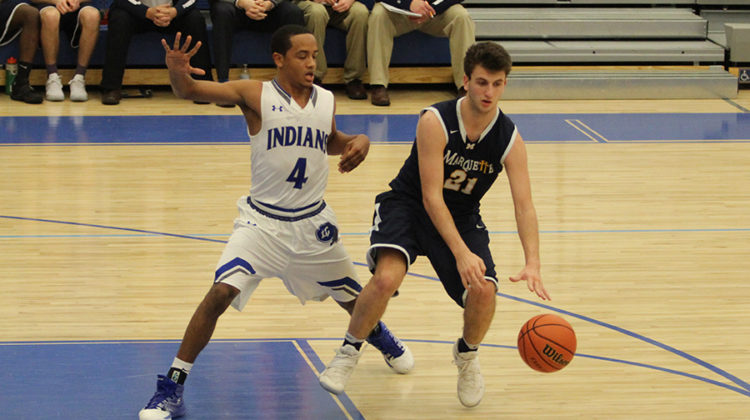 Joe Graziano (12) blocks his opponents shot. Graziano tied the game 61-61 with four minutes left.