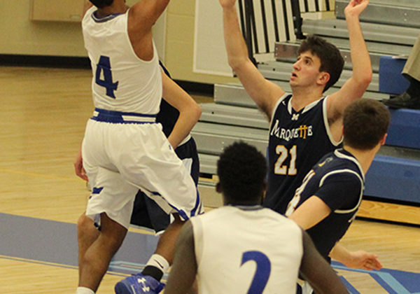 Jumping up to shoot the ball, Graziano (12) stuns his opponent. This shot gained the boys a point and tied the game.