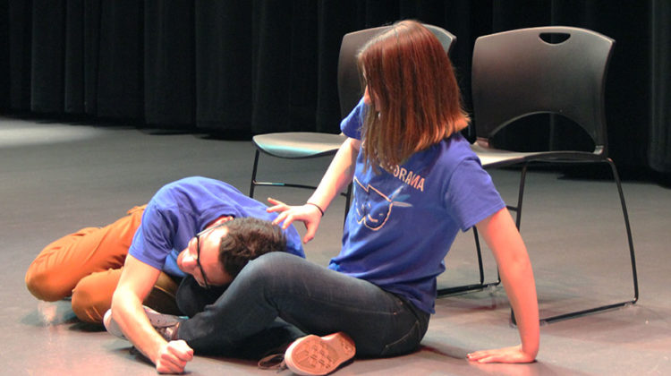 Theodoros Karras (11) and Alexa Spasevski (11) act as though they are on a date in the sketch “Bush People.” They were being coached on how to act by Stephanie Gustas (10) and Erica Habbas (10) who were hiding in the bushes.