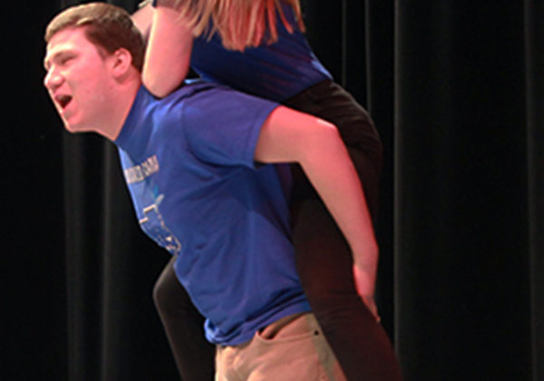 Isabella Gomez (12) sits on Mikey Diaz’s (10) shoulders in a skit where they are stuck in an elevator. Gomez played a hippy who prayed for the greater power to save her.