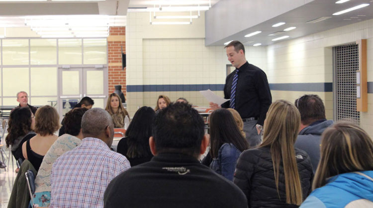 Mr. Todd Smolinski, Social Studies, gives out awards for the girls swim team. After the main ceremony, teams went to separate areas of the school to hand out individual awards to team members.