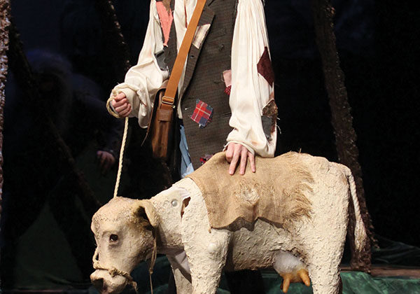 William Kruzan (12) stands on stage with his cow, Milky White, as he travels through the woods. Kruzan played Jack who went into the woods to sell his cow to make money for his family.