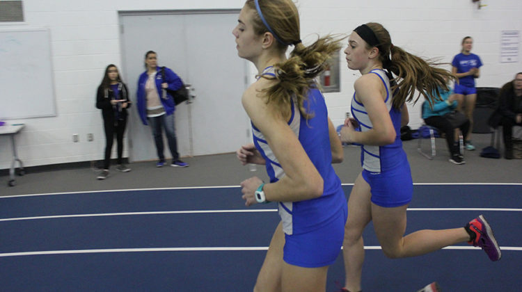 Rachel Kujawa (9) and Lilly Zubeck (9) keep pace together in the mile. Zubeck (second) came in first for the mile and Kujawa (front) came in second.