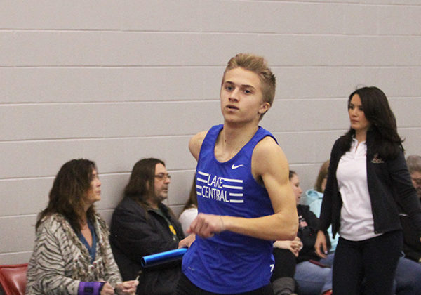 Mitchell Polaski (11) runs down the track, staring at the finish line. Polaski was getting ready to pass the baton onto the next runner during the 4X800-meter race.