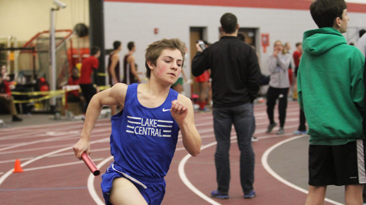 Alexander Miller-Swain (9) sprints down the track in the 4X800-meter relay. Miller-Swain helped bring the boys into first place for the race while he ran.