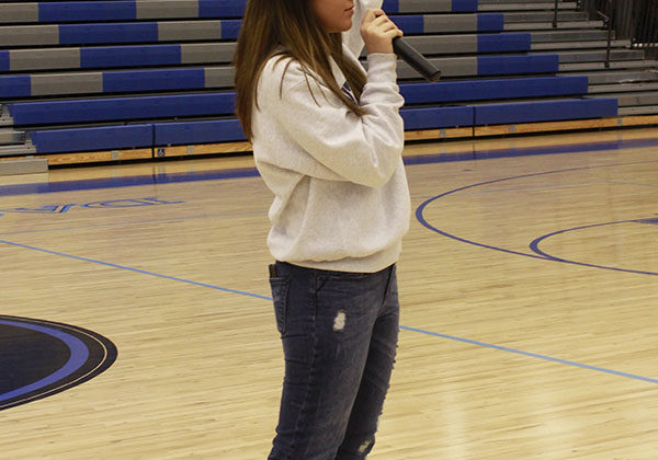 Kaylynn Ward (12) announces the directions. She helped show where each club was to go and give them instructions on what to do.