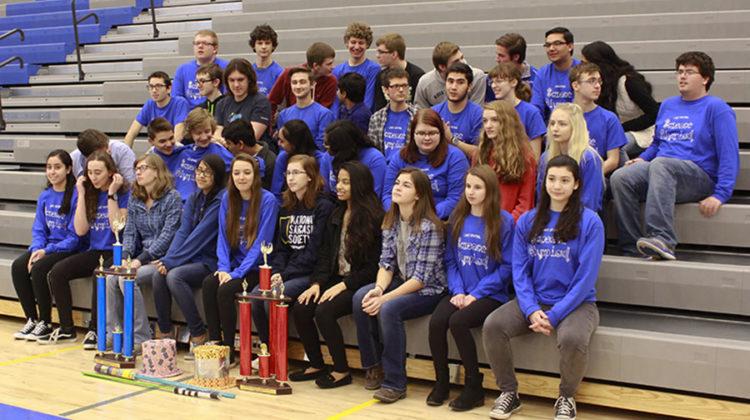 Science Olympiad gathers closely for their picture. The group stayed after to get a less formal picture with their trophies.
