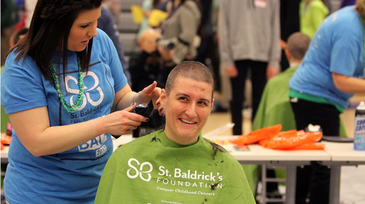 Ms. Carrie Wadycki, Arts, gets her head shaved at the St. Baldrick’s assembly. Ms. Wadycki decided last minute to become a shavee.