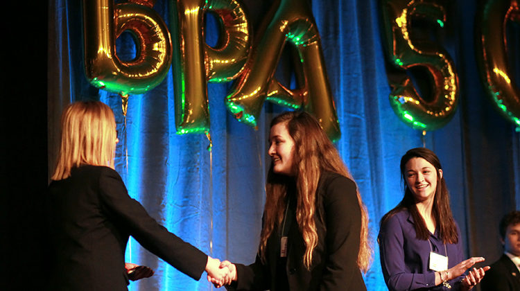Courtney Carlson (11) smiles as her sister Kayla Carlson (10) shakes a BPA District President’s hand after placing tenth in open event Management, Marketing and Human Resource Concepts. Courtney Carlson (11) placed fifth in the same event.