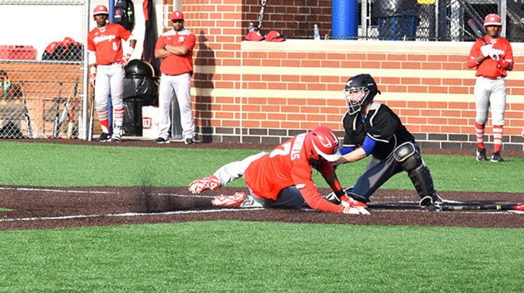 Jarrett Lopez (12) makes an out at home in the fifth inning. The out allowed no runs for Homewood-Flossmoor in the 3-0 win for Lake Central.