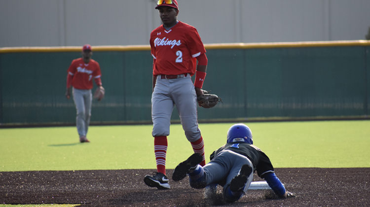 Nicholas Bandura (12) slides into second base after a RBI double in the fifth inning. Bandura has played shortstop in place of Conner Tomasic (11), who is out for the season with an injury.
