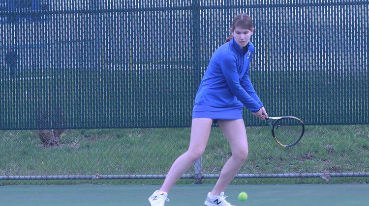 Colette Oboy (11) hits the ball to her opponent. The Indians won their first match of the season a few days before this match was played.