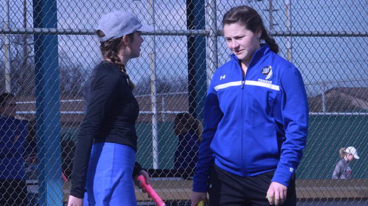 Lauren Gronek (12) and Anna Wachowski (12) joke with each other while practicing before the meet began. Gronek and Wachowski had a successful turnout for the match.