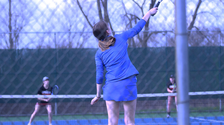 Colette Oboy (11) serves the ball to her opponents on Lowell’s doubles team. Oboy played on varsity doubles with her partner Kaitlin George (12).