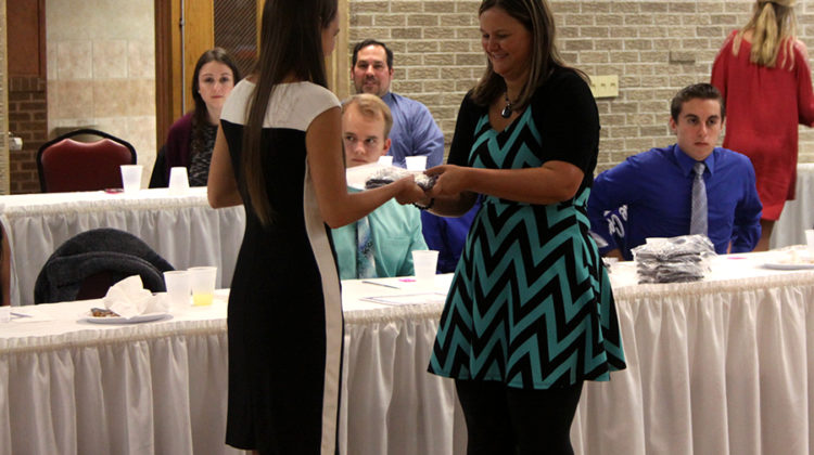 Nicole Geer (12) walks up get get her plaque. All seniors who have been in Academic Letter Winners for seven semester also received a plaque.