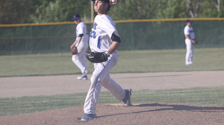 Maxwell Born (10) puffs his cheeks while beginning to throw a pitch. Born’s pitching was very beneficial to the team.