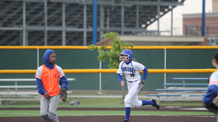 Olivia Peterson (10) sprints to second base through the rain. The game was rained out part way through, so the teams continued the game on May 25.
