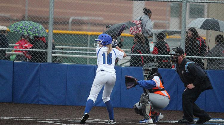 Cheyenne Mathas (11) resists the urge to swing, as the ball comes flying toward her. As she was batting, her teammates showed their support by cheering her on.