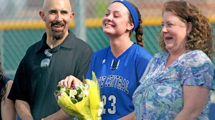 Madison Blythe (12) smiles as with her flowers during the farewell ceremony for senior varsity players. The game was on May 15.