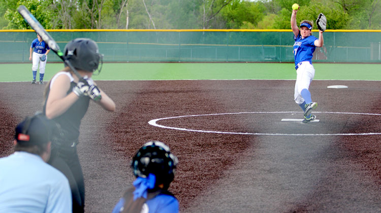 Alexa Pinarski (11) winds up to pitch the ball. There was a ceremony before the game to honor the senior players and manager.
