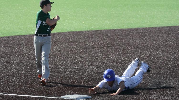 Jake Dykstra (10) slides head-first into third base, beating Illiana’s third baseman there. The baseball team’s senior night is on March 19.