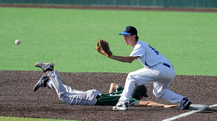 Jack Hilvert (10) extends his arm to catch the ball and to tag his opponent out. Hilvert plays first base for his team.